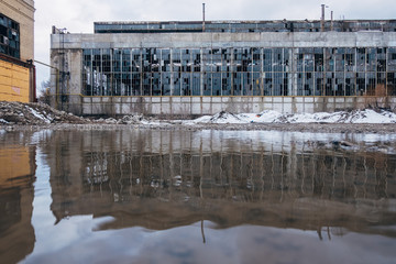 Fototapeta na wymiar Flooded territory of abandoned factory, water reflection