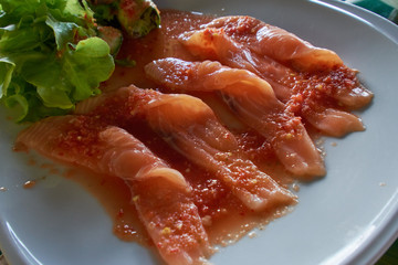 strip raw salmon in spicy salad