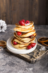 Pancakes with berry on White stone Background, Christmas Dessert. 