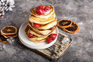 Pancakes with berry on White stone Background, Christmas Dessert. 