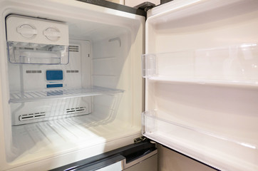 open empty new white refrigerator inside fridge with shelves .