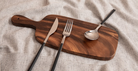 Cutlery set on a wooden cutting board