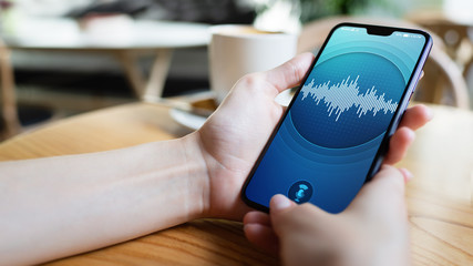 Voice recognition application on smartphone screen. Artificial intelligence and deep learning concept.