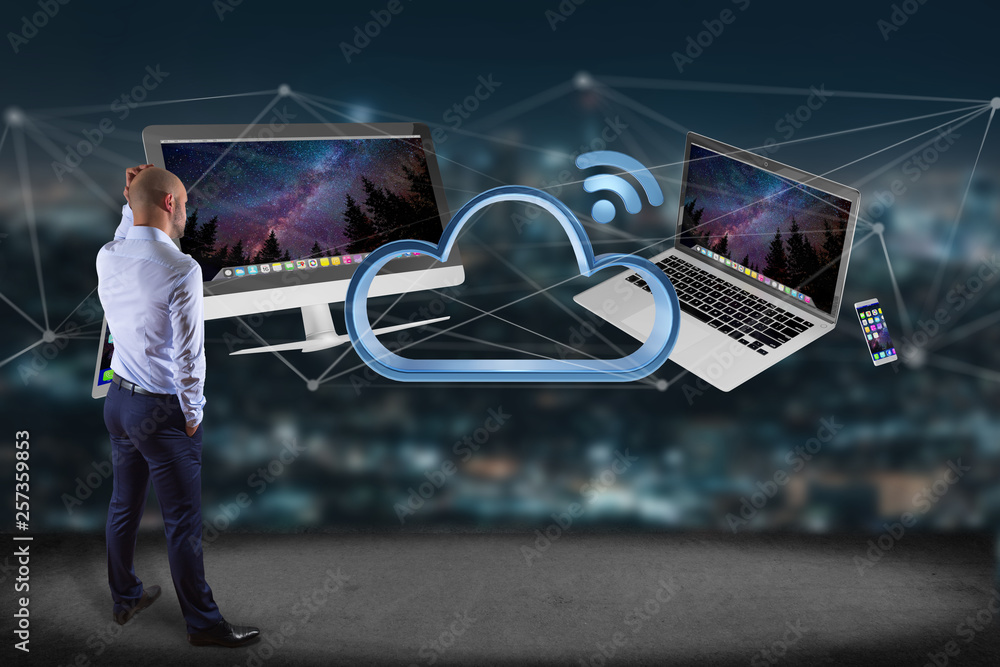 Poster businessman in front of a wall with devices like smartphone, tablet or computer flying over connecte