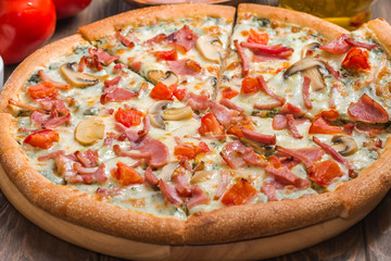 Delicious pizza with ingredients served on wooden table