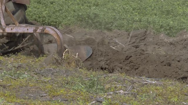 Farmer plow his field with old tractor 2