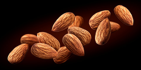 Flying almond isolated on black background