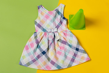 baby color dress on green and yellow background, the concept of summer