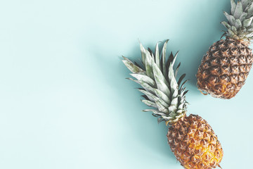 Summer composition. Pineapples on pastel blue background. Summer concept. Flat lay, top view, copy space