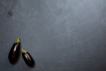 Eggplant or aubergine on dark background with copy space for your text. Top view. Flat lay.