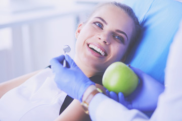 Close up portrait of healthy smiling woman with green apple.