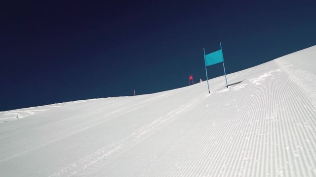 slow motion skier in race suit skiing giant slalom