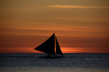 Fototapeta na wymiar Sailing boat silhouette on sunset background