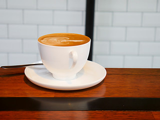 cup of coffee on wooden table.