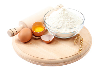 Flour eggs wheat ears on white background