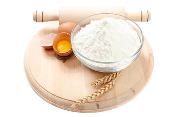 Flour eggs wheat ears on white background