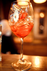 glasses of cocktails on the bar. bartender pours a glass of sparkling wine with Aperol.