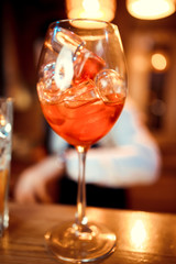 glasses of cocktails on the bar. bartender pours a glass of sparkling wine with Aperol.