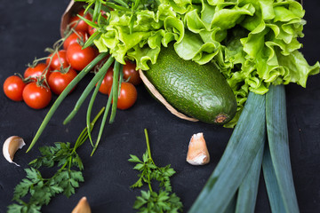 Fresh vegetables: cabbage, avocado, tomato, rosemary, garlic, mushrooms, leeks