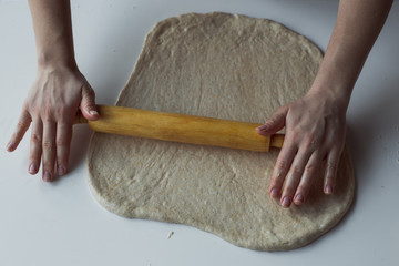 Woman kneading dough on kitchen table
