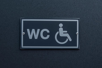 Disable toilet sign at a restroom door,Wheelchair icon, - image