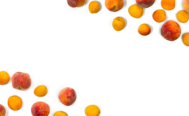 Frame of fresh orange apricots and peaches fruits on white background with space for text. Top view, flat lay