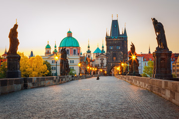 Fototapeta premium Scenic view on Vltava rive, Charles bridge and historical center of Prague, buildings and landmarks of old town at sunset, Prague, Czech Republic