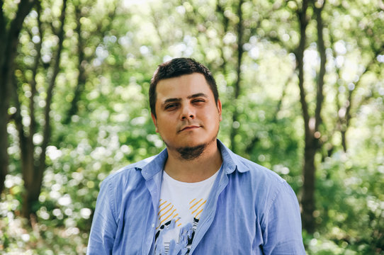 Portrait Of Overweight Hipster Guy In The Wood. Outdoors Photoshoot For A Handsome Man.