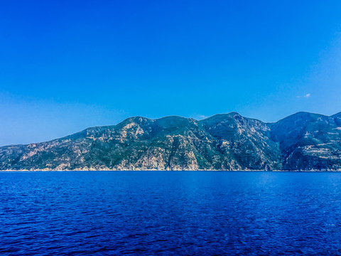 Scenic View Of Mountains And Sea Against Clear Blue Sky