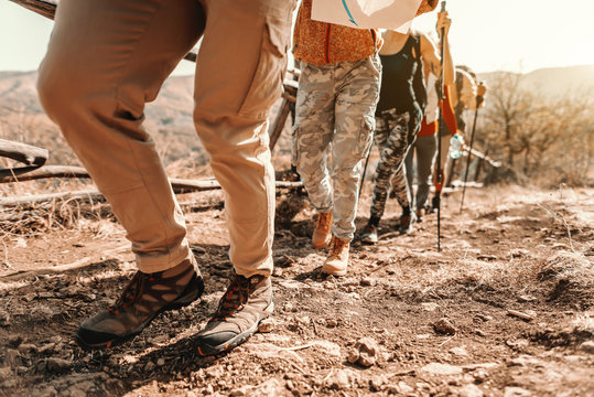 Close Up Of Hikers' Feet Climbing. Hiking In Nature At Autumn Concept.