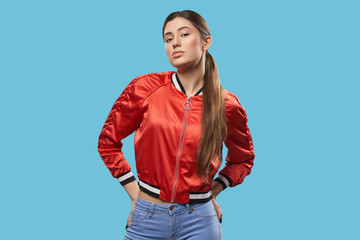 Youth style. Portrait of model in bright red bomber.