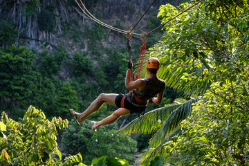 Men are playing zip line.