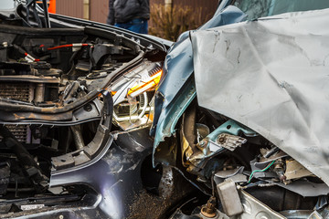 Car accident on a road, parts of cars after frontal collision