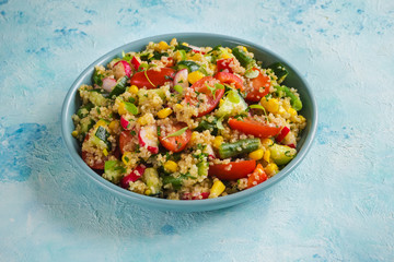 Quinoa salad with green leaves and vegetables. 