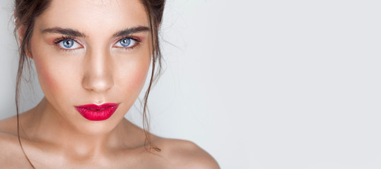 Beauty portrait of sexy young woman with red lips. Pure and nude make up.