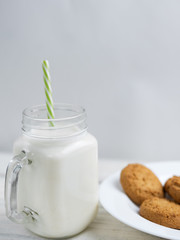 oatmeal cookies with milk on wooden background