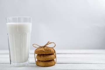 oatmeal cookies with milk on wooden background