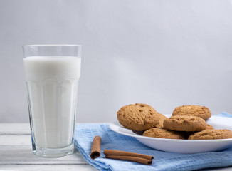 oatmeal cookies with milk on wooden background