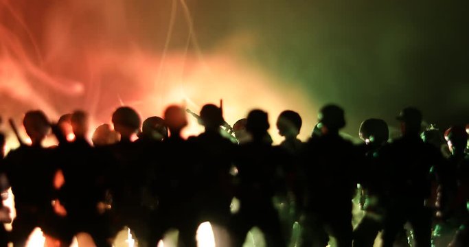 Anti-riot police give signal to be ready. Government power concept. Police in action. Smoke on a dark background with lights. Blue red flashing sirens. Dictatorship power