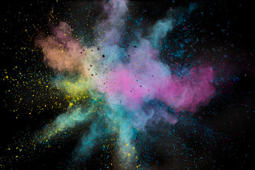 Colored powder explosion on black background. Freeze motion.