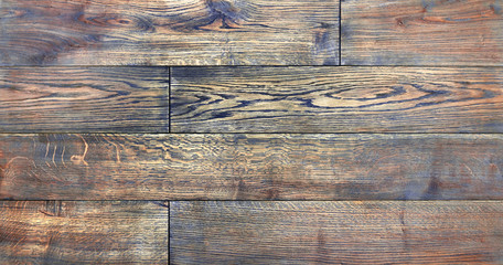 Naklejka premium parquet from solid wood. sample of parquet. texture or background. wood texture. board. painted with natural oil. wax. mastic. imitation of valuable species of wood.