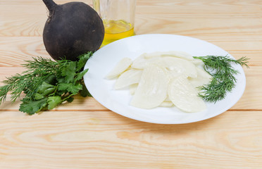 Vegetable salad of sliced black radish and vegetable oil