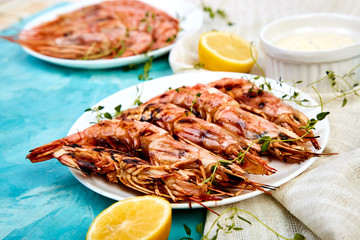 Grilled big tiger shrimps prawns on white plate
