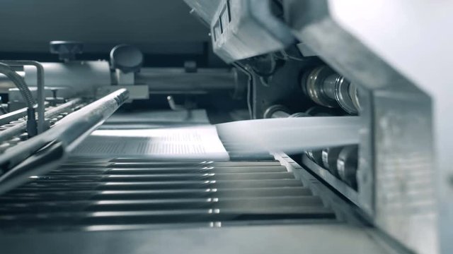 Transporter with paper getting released onto it