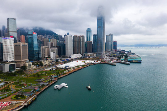 Hong Kong, China - March, 24, 2019: KAWS:holiday Following the trips in Seoul and Taipei, I came to Hong Kong this time.I am now lying on the surface of the Victoria Harbour, basking  in the sunshine.