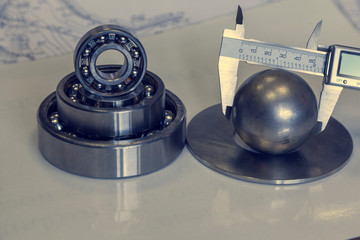 Diameter measurement with calipers, bearings, toned.