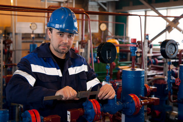 A repair technician makes a caliper gauge a flange connection on the fittings of gas equipment