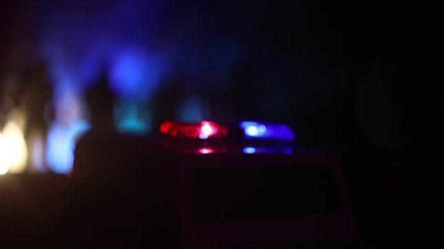 Police cars at night. Police car chasing a car at night with fog background. 911 Emergency response police car speeding to scene of crime. Selective focus
