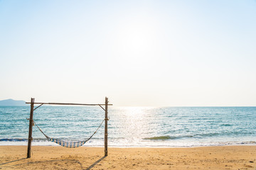 Empty hammock swing on the beautiful beach and sea