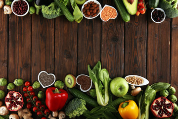 Healthy food clean eating selection. fruit, vegetable, seeds, superfood, cereals, leaf vegetable on rustic background